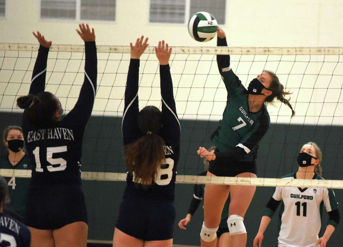 Guilford's Emma Appleman (7) takes a shot as East Haven's Brooke Clancy (15) and Kayla Stefania (28) defend during the SCC Div. C volleyball final in Guilford on Friday, Nov. 13, 2020.