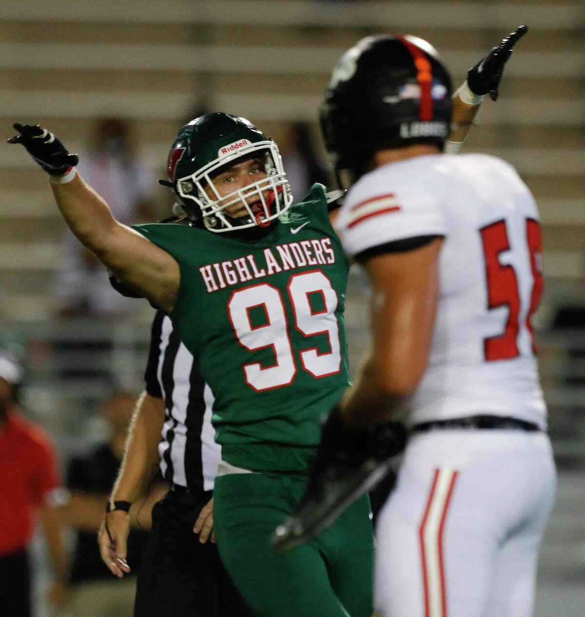 The Woodlands defensive linemen John Podowski (99) reacts after sacking Langham Creek quarterback Tanner Murray (7) with linebacker David Ifeanyi (18) during the first quarter of a non-district high school football game at Woodforest Bank Stadium, Thursday, Aug. 26, 2021, in Shenandoah.