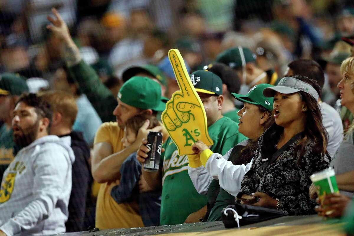 Oakland Athletics' fans cheer during 7th inning stretch while A's play New York Yankees during MLB game at Oakland Coliseum in Oakland, Calif., on Thursday, August 26, 2021.