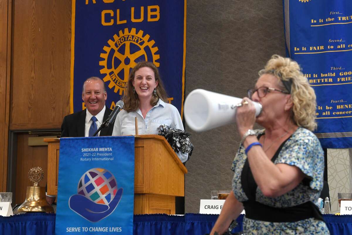 Rotary members cheer as they make their way up to announce the next Wine Down with Rotary event at the weekly Beaumont Rotary Club meeting Wednesday. Photo made Wednesday, August 25, 2021 Kim Brent/The Enterprise