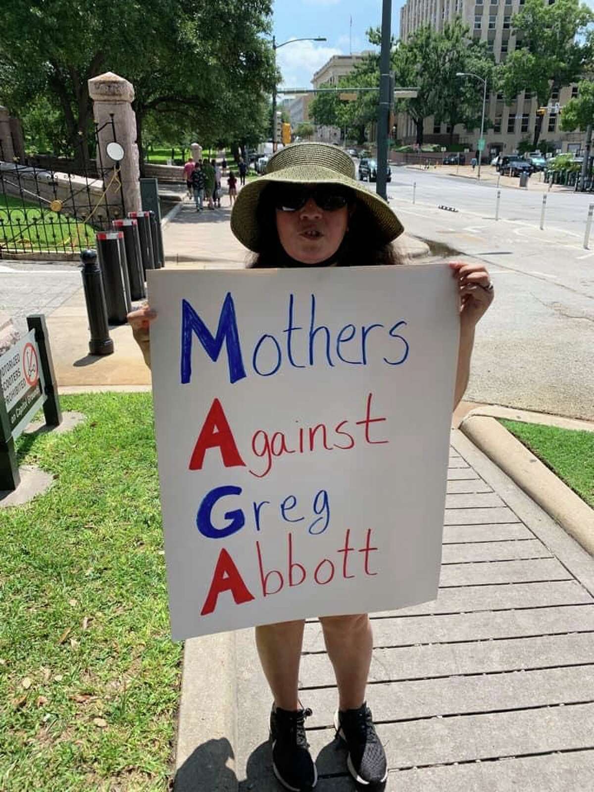 Mothers Against Greg Abbott founder Nancy Thompson is seen protesting outside of the Austin Capitol on Aug. 6. The 51-year-old said she's fed up with Gov. Greg Abbott's face mask policies.