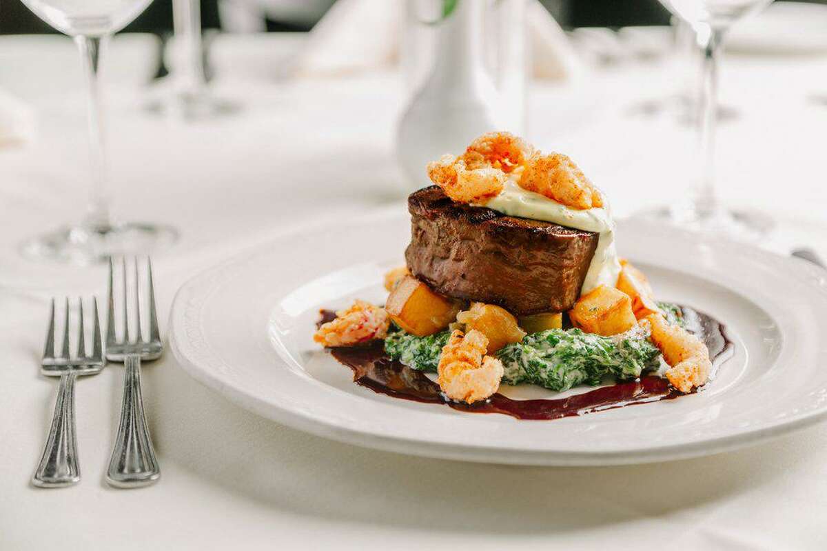 The house tenderloin beef filet is topped with fried crawfish tails and bearnaise sauce at Christopher's World Grille in Bryan.