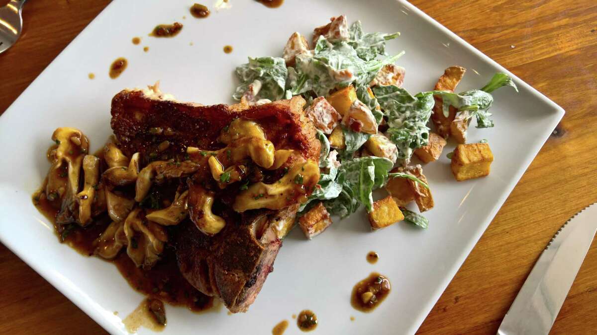 Pan-seared veal porterhouse with warm potato salad and mushroom veal demi at the West Table restaurant in Lubbock, Texas.