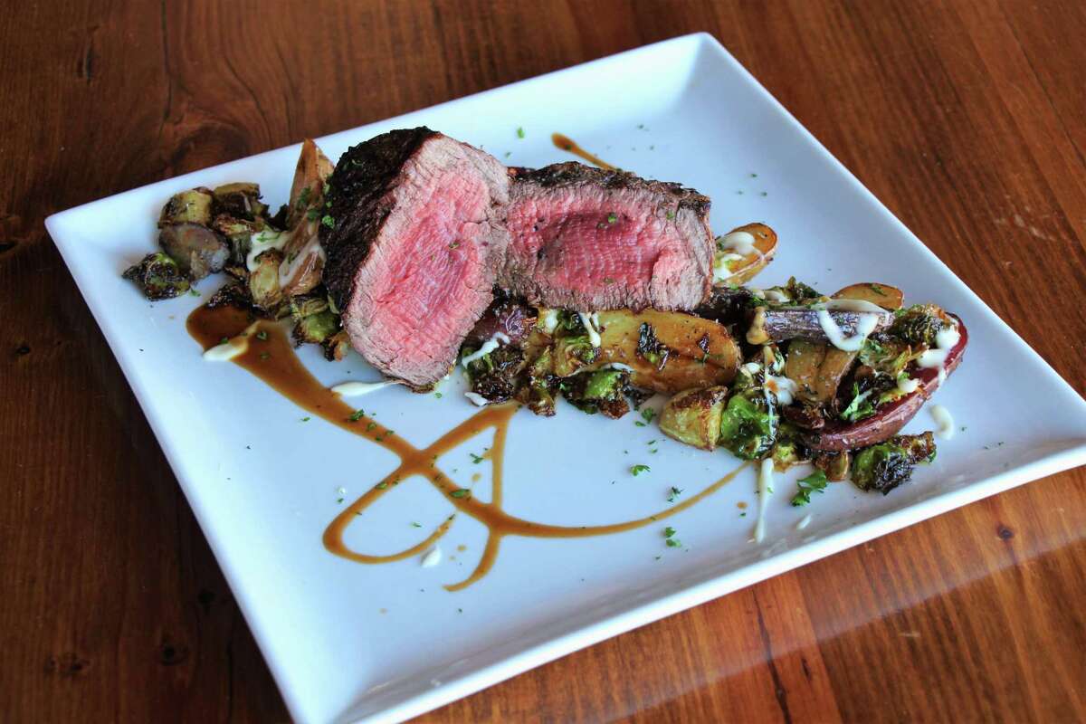 Charbroiled beef tenderloin with roasted fingerling potatoes, fried Brussels sprouts, and asiago mornay at the West Table restaurant in Lubbock, Texas.