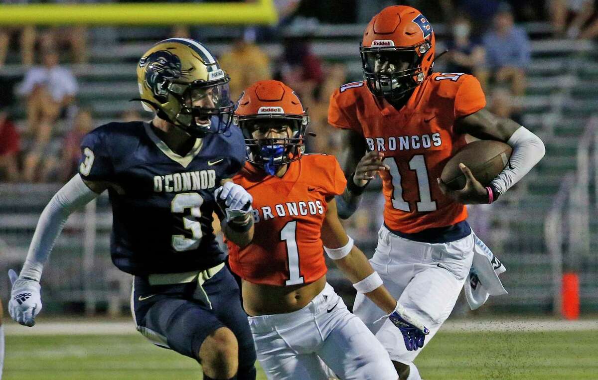 Brandeis QB JC Evans gets blocking from Aiden Inesta-Rodriquez(1) as he scrambles against O'Connor. Brandeis defeated O'Connor 33-7 in boys football game on Thursday, Oct. 26, 2021 at Farris Stadium.