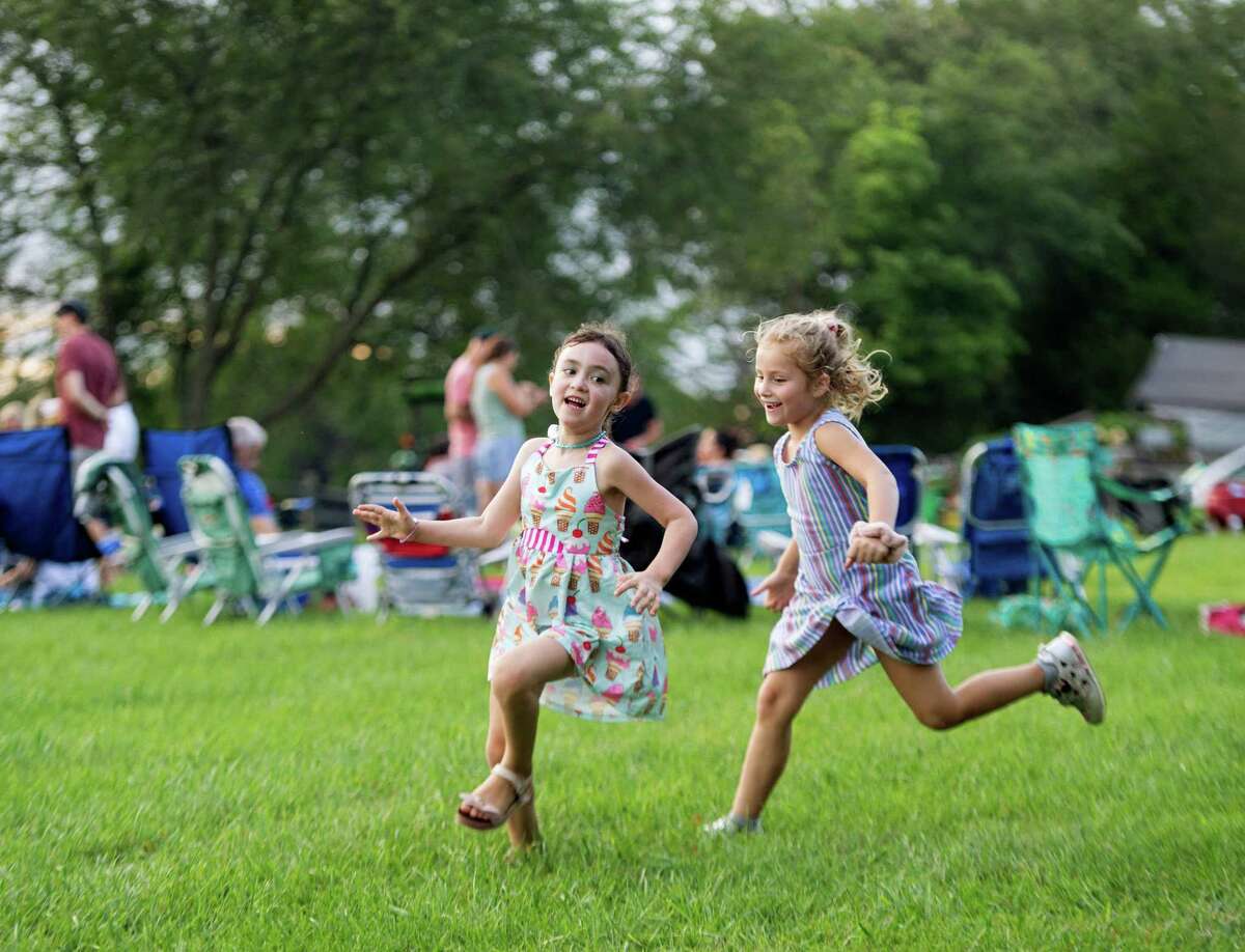 Vienna Eriksen and Amelia Ruggiero play Duck, Duck, Goose at Ambler Farm's Sayonara to Summer concert with Grateful Dead tribute band, Bear's Choice, on Saturday, Aug. 21, 2021, in Wilton, Connecticut.