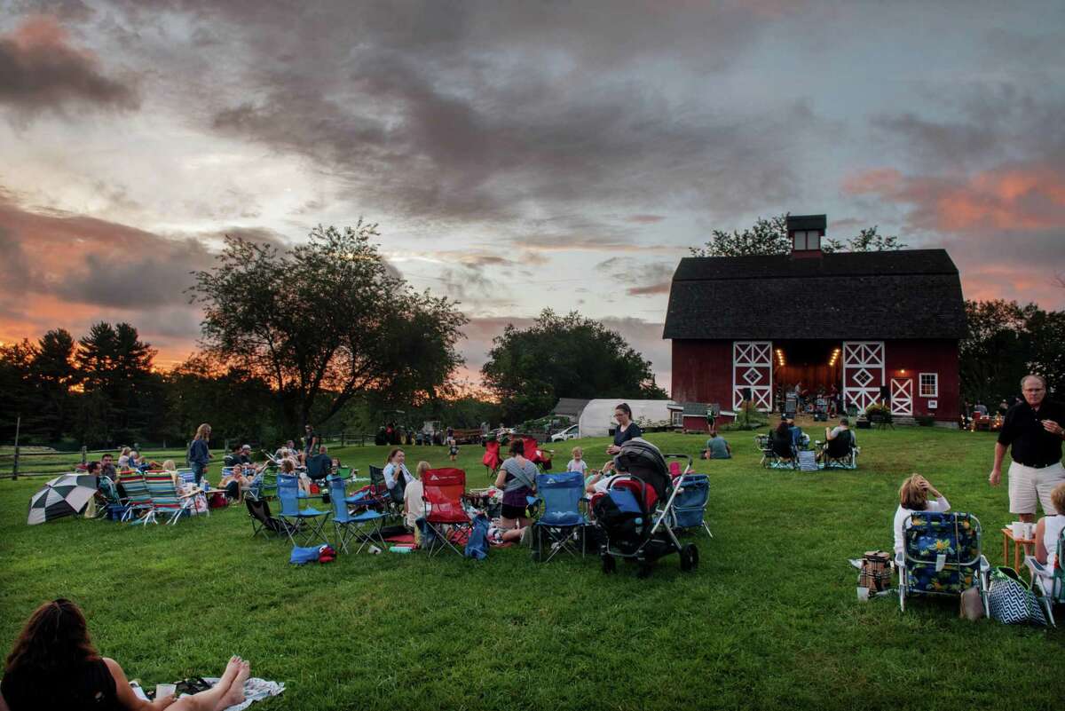 The sun sets at Ambler Farm's Sayonara to Summer concert with Grateful Dead tribute band, Bear's Choice, on Saturday, Aug. 21, 2021, in Wilton, Connecticut.