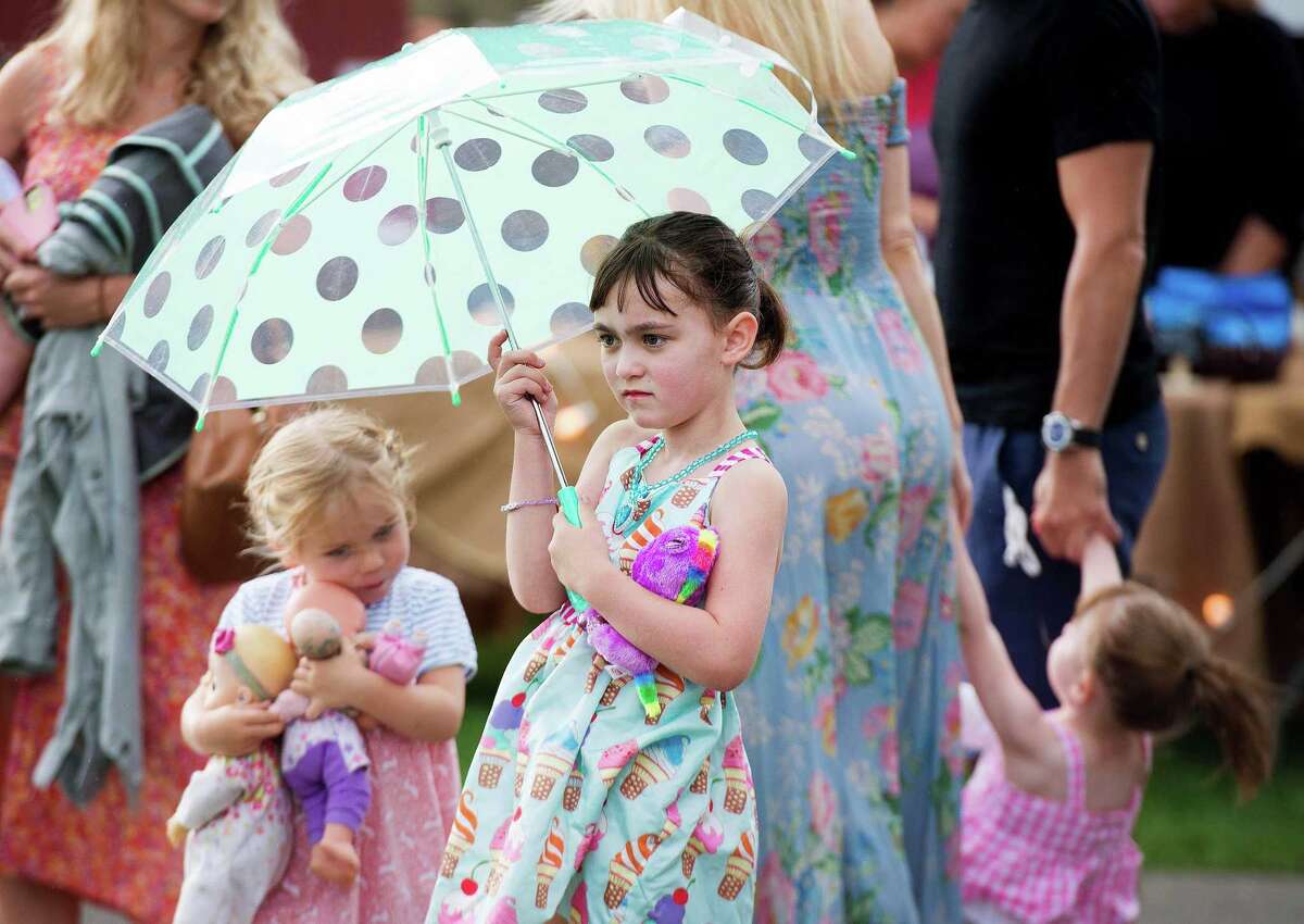 6-year-old Vienna Eriksen is prepared for upcoming storms while attending Ambler Farm's Sayonara to Summer concert featuring Grateful Dead tribute band, Bear's Choice, on Saturday.