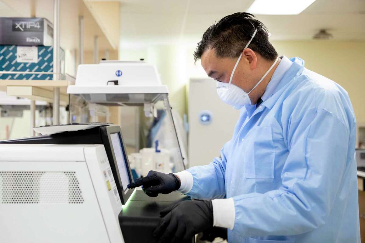 UCSF virologist Dr. Charles Chiu demonstrates a machine that sequences virus genetic material. Chiu says he’s “very worried about variants for which vaccines may be less effective.”