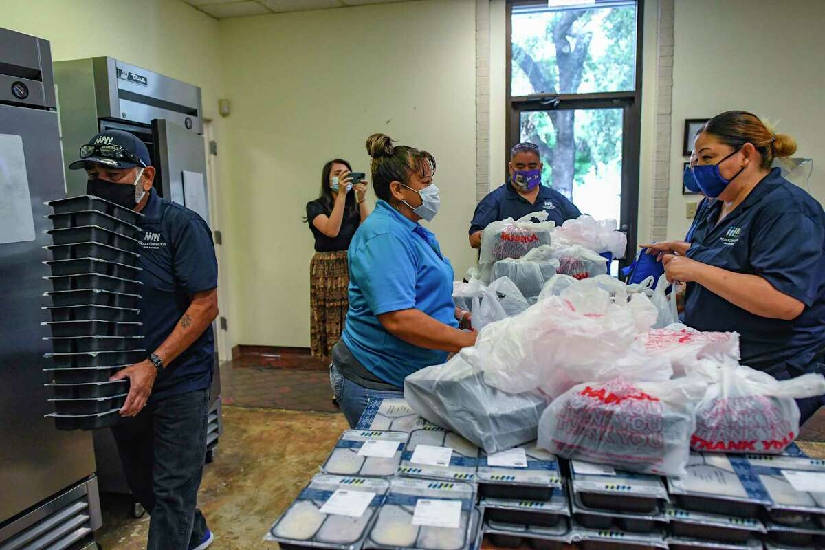 Delivery drivers pack bags at Meals on Wheels for delivery to area seniors on Aug. 10, 2021.