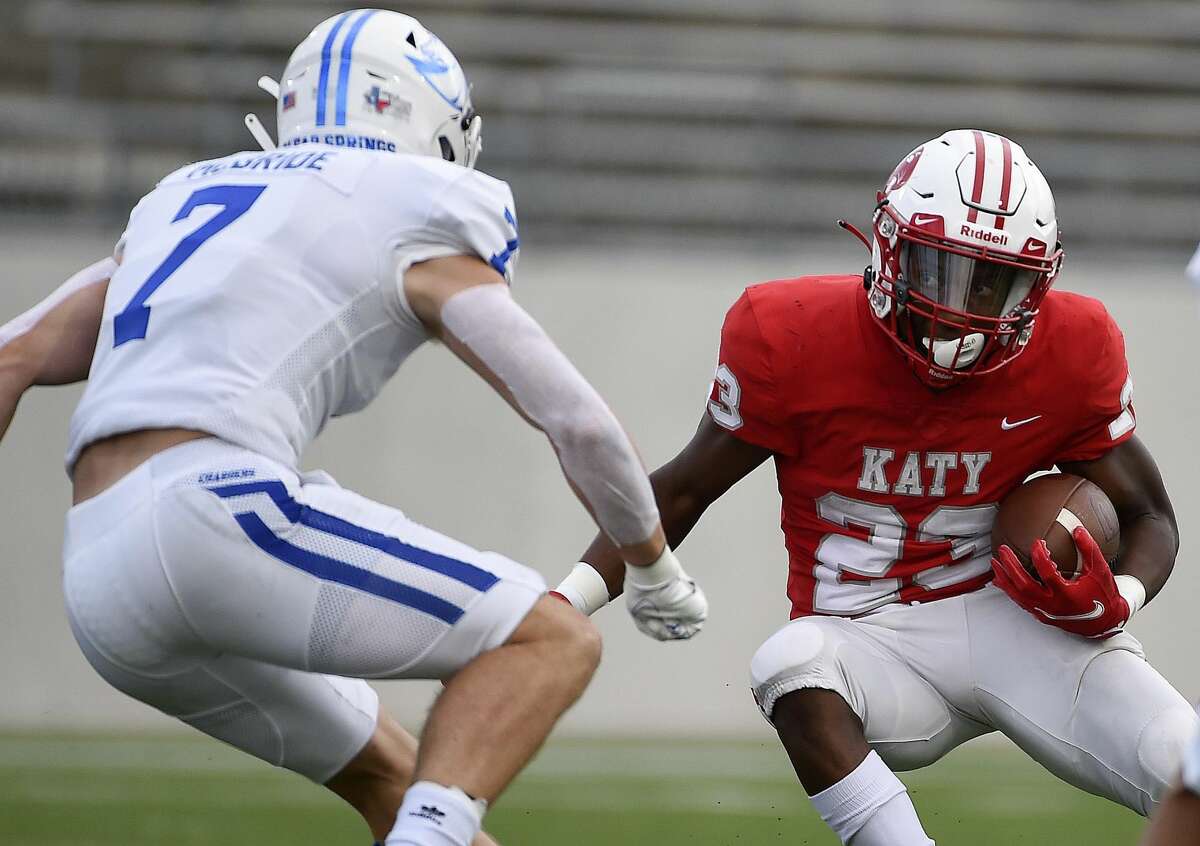 Katy running back Seth Davis, right, rushes the ball as Clear Springs defensive back Michael McBride defends during the first half of a high school football game, Friday, Aug. 27, 2021, in Katy.