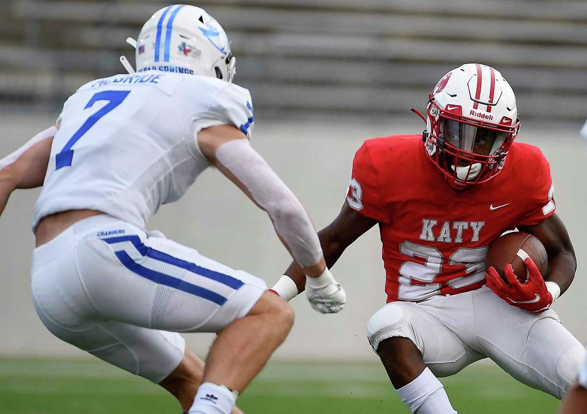 Katy running back Seth Davis tries to elude Clear Springs defensive back Michael McBride during the first half of a high school football game Friday in Katy.