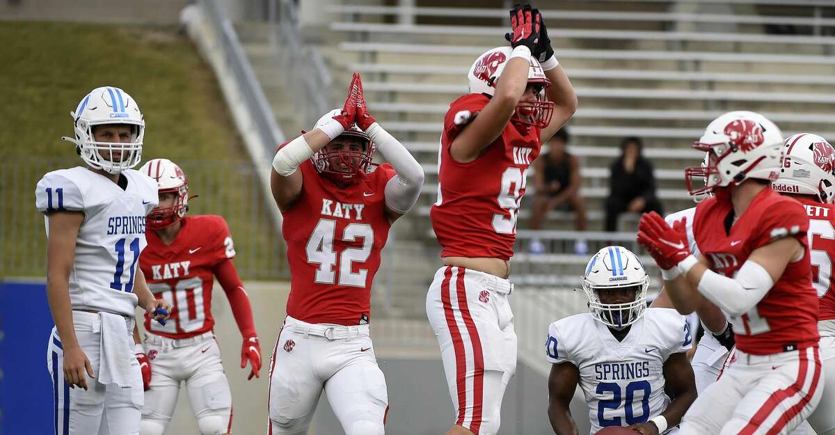 Katy linebacker Ty Kana (42) and defensive lineman Caydens Robertson, right, signal safety after tackling Clear Springs running back Xai-Shaun Edwards (2) in the end zone for a safety on the first play of the game during the first half of a high school football game, Friday, Aug. 27, 2021, in Katy.