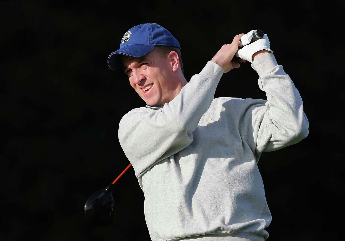 Peyton Manning, who was then the Denver Broncos quarterback, hits a tee shot during a practice round for the AT&T Pebble Beach National Pro-Am at Pebble Beach Golf Links on Feb. 5, 2014, in Pebble Beach, Calif.