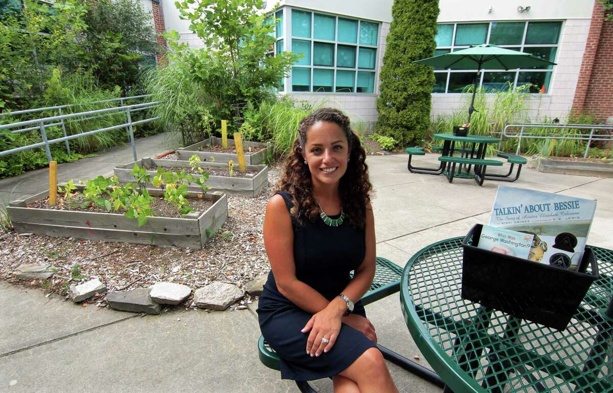 Brookside Elementary School Principal Christina Guerra poses at the school's outdoor garden in Norwalk, Conn., on Friday August 27, 2021.