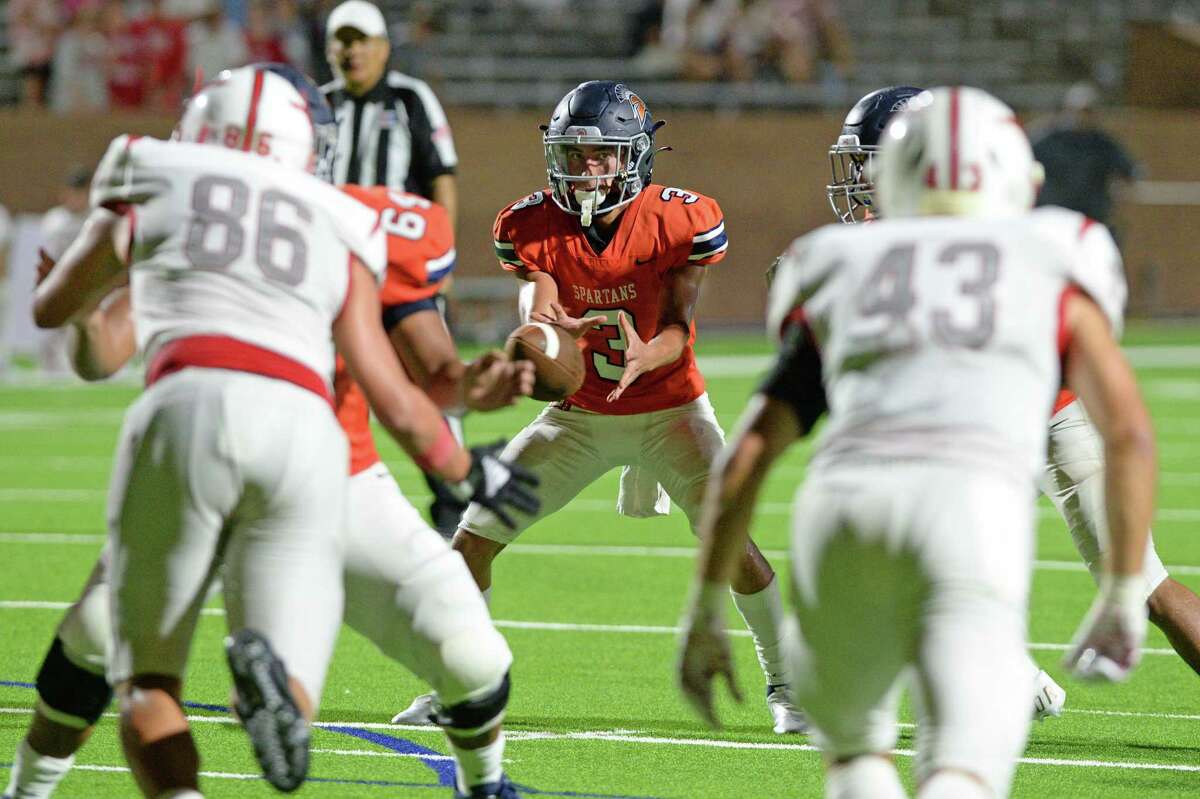 Grayson Medford (3) of Seven Lakes takes a snap during the fourth quarter of a non-District football game between the Seven Lakes Spartans and the Memorial Mustangs on Friday, August 27, 2021 at Rhodes Stadium, Katy, TX.