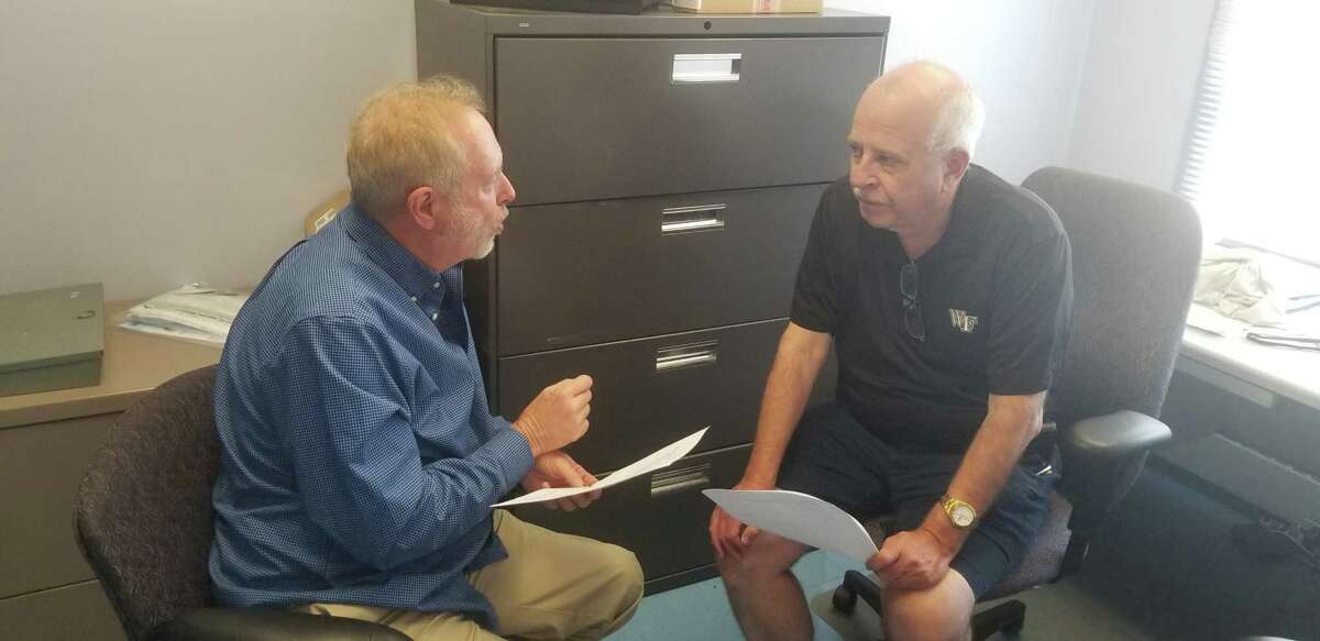 AAU president and CEO Jennings "Rusty" Buchanan discusses an issue with Jack Bethke, the governor of Connecticut AAU, on Friday at The Sound School in New Haven.