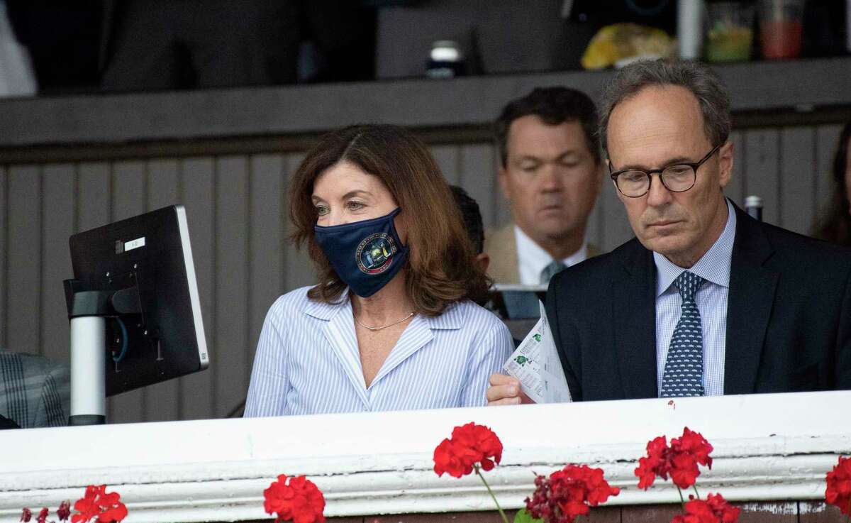 Gov. Kathy Hochul, left, and her husband Bill Hochul watch Essential Quality duels with Midnight Bourbon to win the Travers Stakes at Saratoga Race Course Saturday Aug. 28, 2021 in Saratoga Springs, N.Y. 