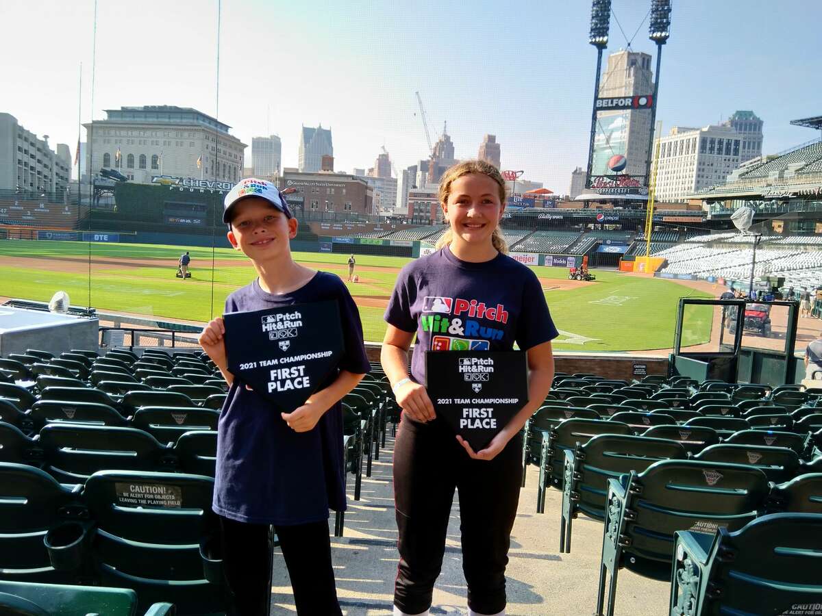 Midland's Grayson Skorup and Maggie Frazee pose with the championship plaques they earned by winning their respective divisions at the Major League Baseball Pitch, Hit and Run regional competition at Comerica Park in Detroit on Saturday, Aug. 28, 2021.