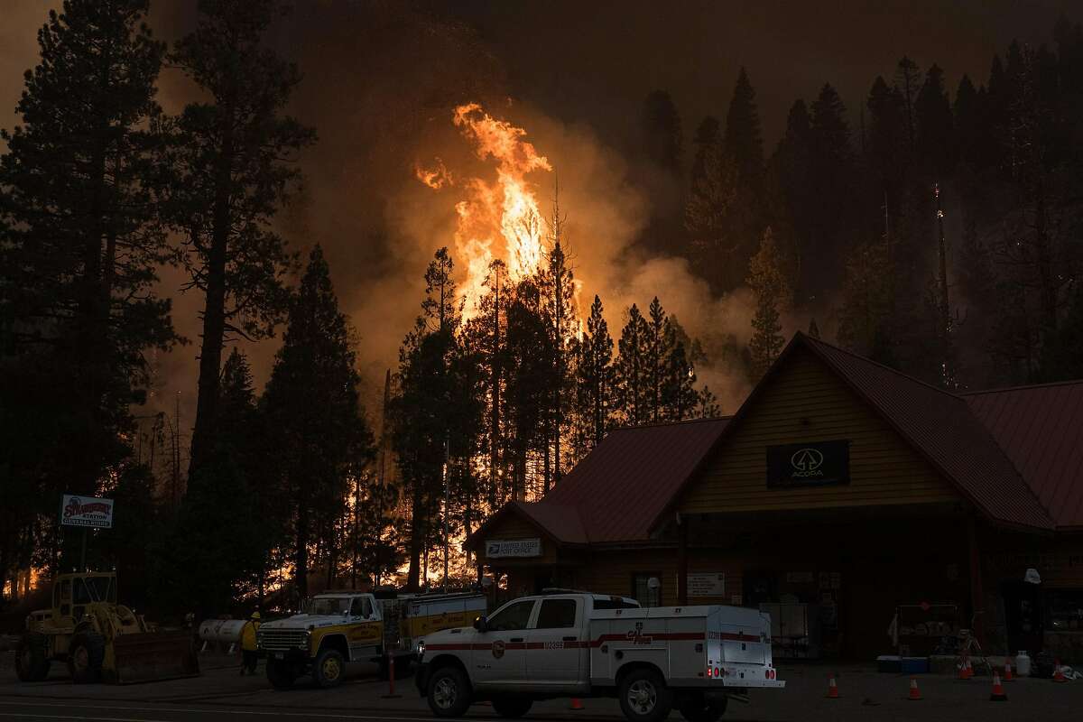 A controlled backfire burns behind the Strawberry Station General Store in El Dorado County during the Caldor Fire.