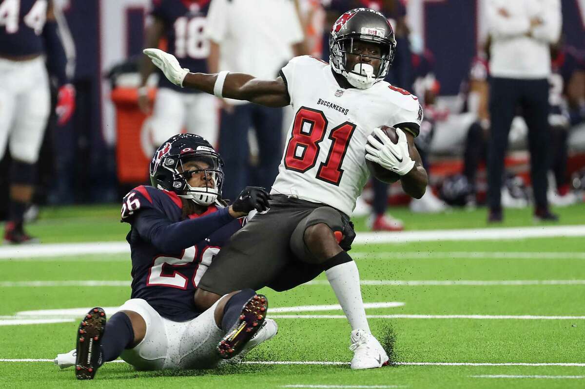 Tampa Bay Buccaneers wide receiver Antonio Brown (81) makes a catch against Houston Texans cornerback Vernon Hargreaves III (26) during the first half of an NFL football game Saturday, Aug. 28, 2021, in Houston.
