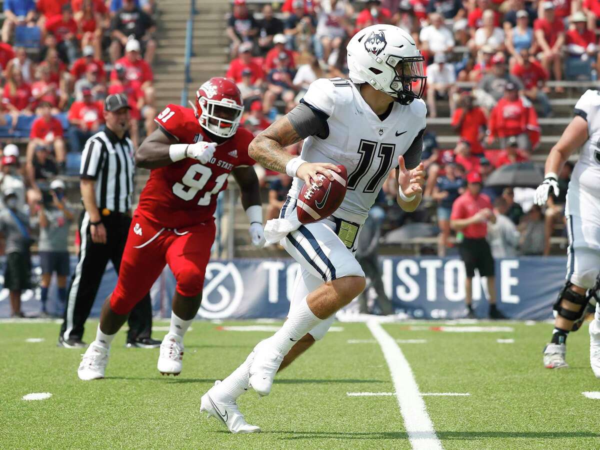 UConn’s Jack Zergiotis (11) looks fir running room as Fresno State's Matt Lawson gives chase during the first half Saturday in Fresno, Calif.