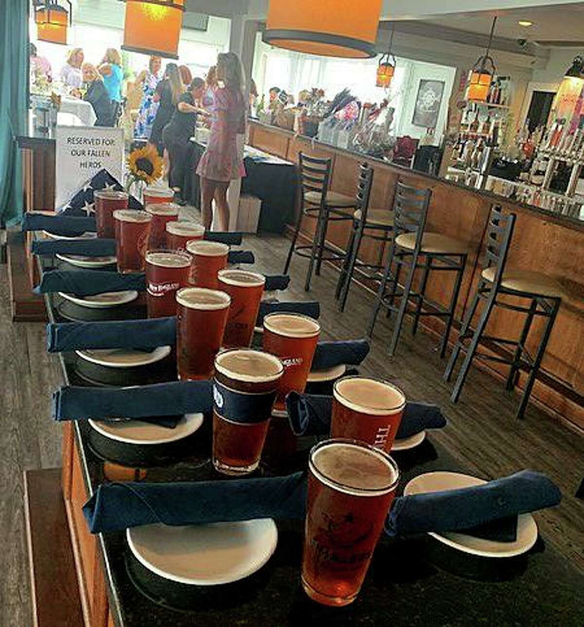 Amid the table settings at Guilford Mooring Restaurant, poured pints of Thimble American Ale and an American flag folded for burial, was a sign that read, “Reserved for our Fallen Heroes.”