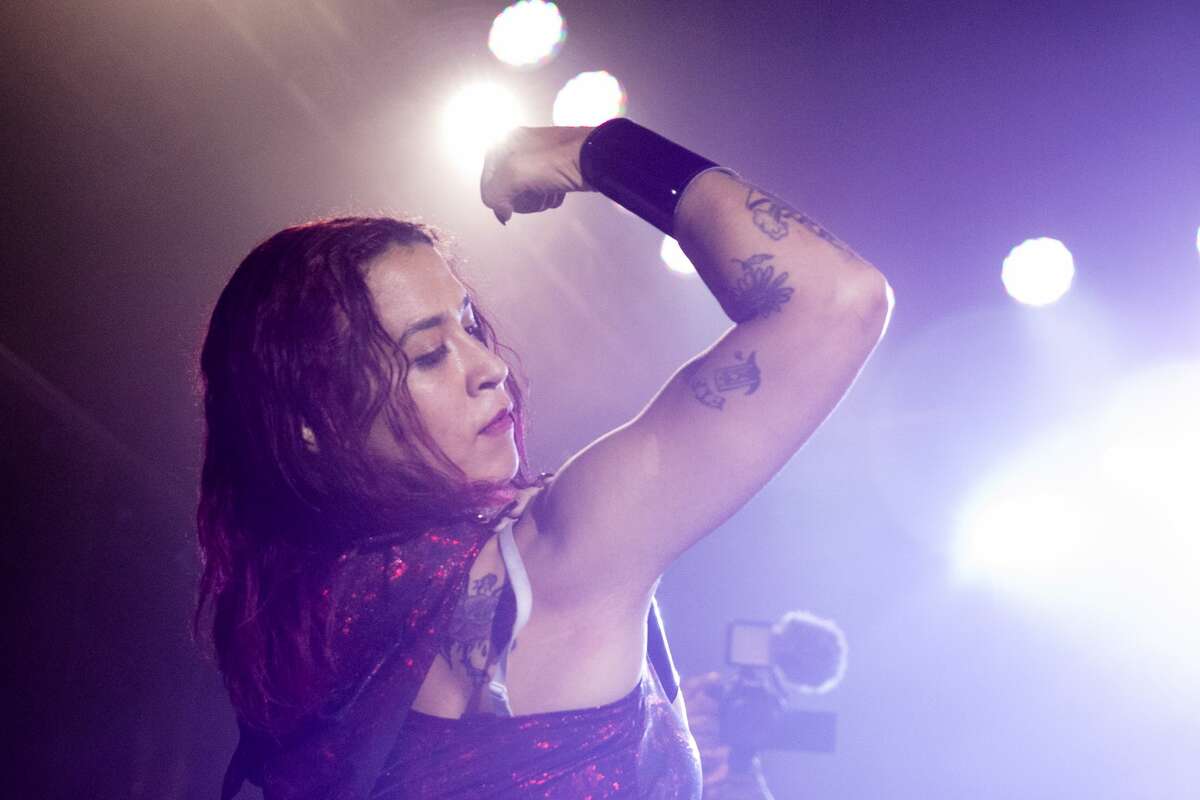 Wrestler Brittany Wonder shows off her muscles at the Hoodslam underground pro wrestling show at the DNA Lounge in San Francisco on Aug. 22, 2021.