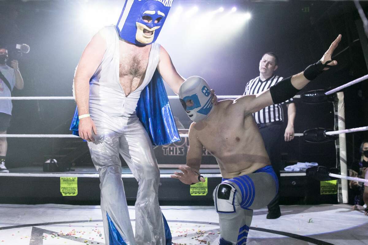 Cereal Man, left, wrestles BART-Man during the first Hoodslam match at DNA Lounge in San Francisco on Aug. 22, 2021.