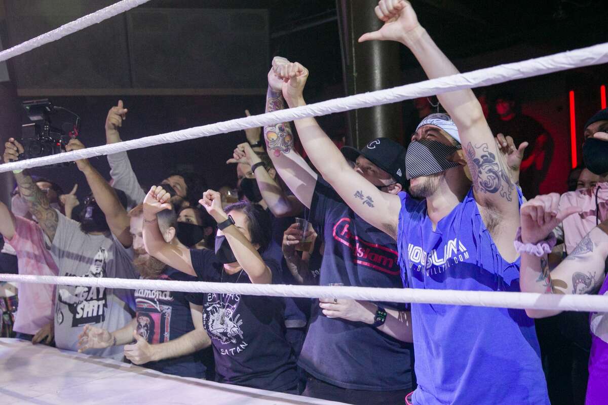 Spectators cheer and boo during the Hoodslam underground pro wrestling show at the DNA Lounge in San Francisco on Aug. 22, 2021.