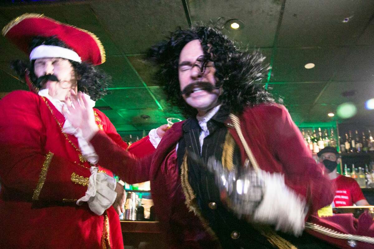 Wrestler Cap'n Morgan is slapped by Captain Hook after sharing a drink at the bar during a Hoodslam match at DNA Lounge in San Francisco on Aug. 22, 2021.