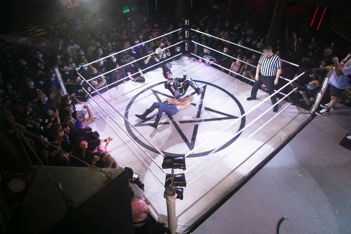 Wrestler El Chupacabra prepares to land on Johnny Butabi during a Hoodslam match at DNA Lounge in San Francisco on Aug. 22, 2021.