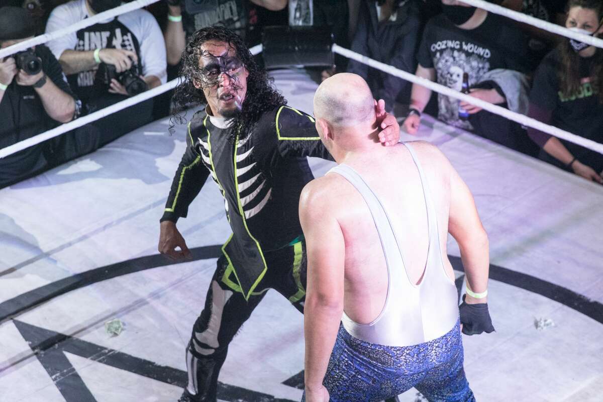 Wrestler El Chupacabra prepares to hit Johnny Butabi during a Hoodslam match at DNA Lounge in San Francisco on Aug. 22, 2021.