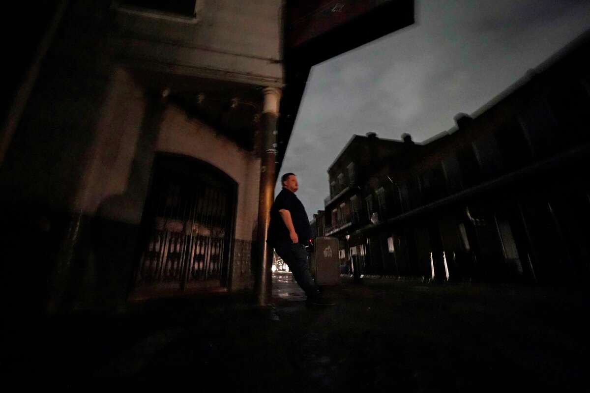 Greg Nazarko, manager of the Bourbon Bandstand bar on Bourbon Street, leans against a pole outside the club where he rode out Hurricane Ida that knocked out power in New Orleans, Monday, Aug. 30, 2021.