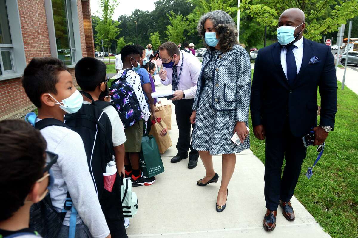 Supt. of School Alexandra Estrella walks with Deputy Supt. Thomas McBryde as the greet students arriving for the first day of class at Jefferson Elementary School, on the Ponus Ridge STEAM Academy campus in Norwalk, Conn. Aug. 30, 2021.