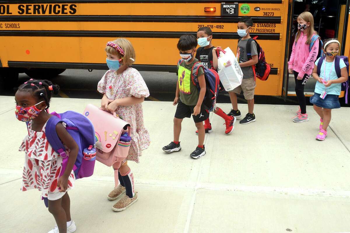 Students arrive for the first day of class at Jefferson Elementary School, on the Ponus Ridge STEAM Academy campus in Norwalk, Conn. Aug. 30, 2021.