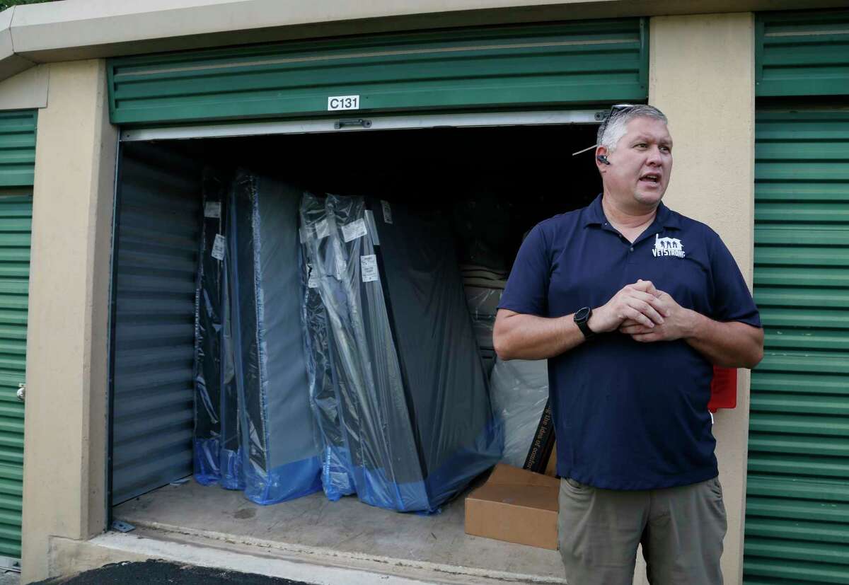 VetStrong founder and Afghanistan veteran James Pobanz waits for other veterans at a warehouse beds and furniture are stored on Saturday, Aug. 28, 2021. The beds and furniture will be delivered to the Wurzbach Manor apartments.
