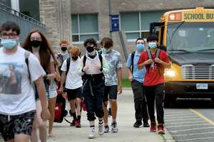 Students arrive for the first day of school at Fairfield Ludlowe High School in Fairfield, Conn. on Aug. 30, 2021.