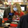 File photo. Julia Barnum of Newtown wears a mask while working at Stew Leonard's in Danbury, Conn. Tuesday, April 21, 2020. Newtown has imposed a mask mandate for indoor public spaces. Monday Aug. 30, 2021.