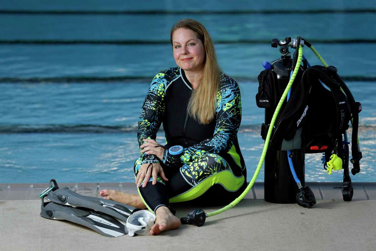 Caroline Wolbrecht, an avid scuba diver, at the Dow Park swimming pool near her home Wednesday, Aug. 25, 2021 in Deer Park, TX. Wolbrecht thought she had skin bends which would end her diving. It turned out to be a condition known as PFO, which she had corrected through surgery, allowing her to continue diving.