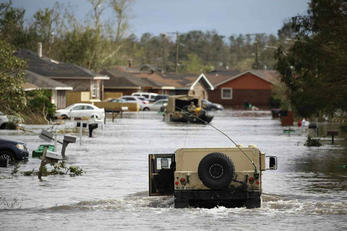 A National Guard vehicle drives through floodwaters in LaPlace, La., on Monday in the aftermath of Hurricane Ida.