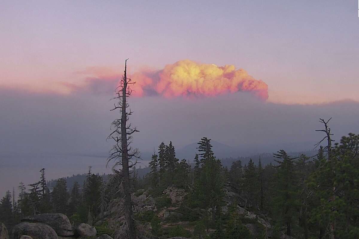 The huge plume of the Caldor Fire looms over the sunset near South Lake Tahoe on Aug. 30, 2021.