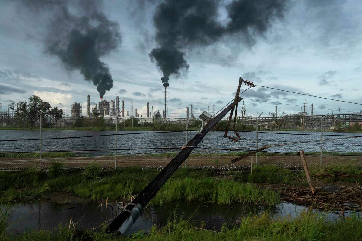 LAPLACE LA - AUGUST 30 Broken power lines, destroyed by Hurricane Ida, are seen along a highway near a petroleum refinery on August 30, 2021 outside LaPlace, Louisiana. Idas eastern wall went right over LaPlace inflicting heavy damage on the area.