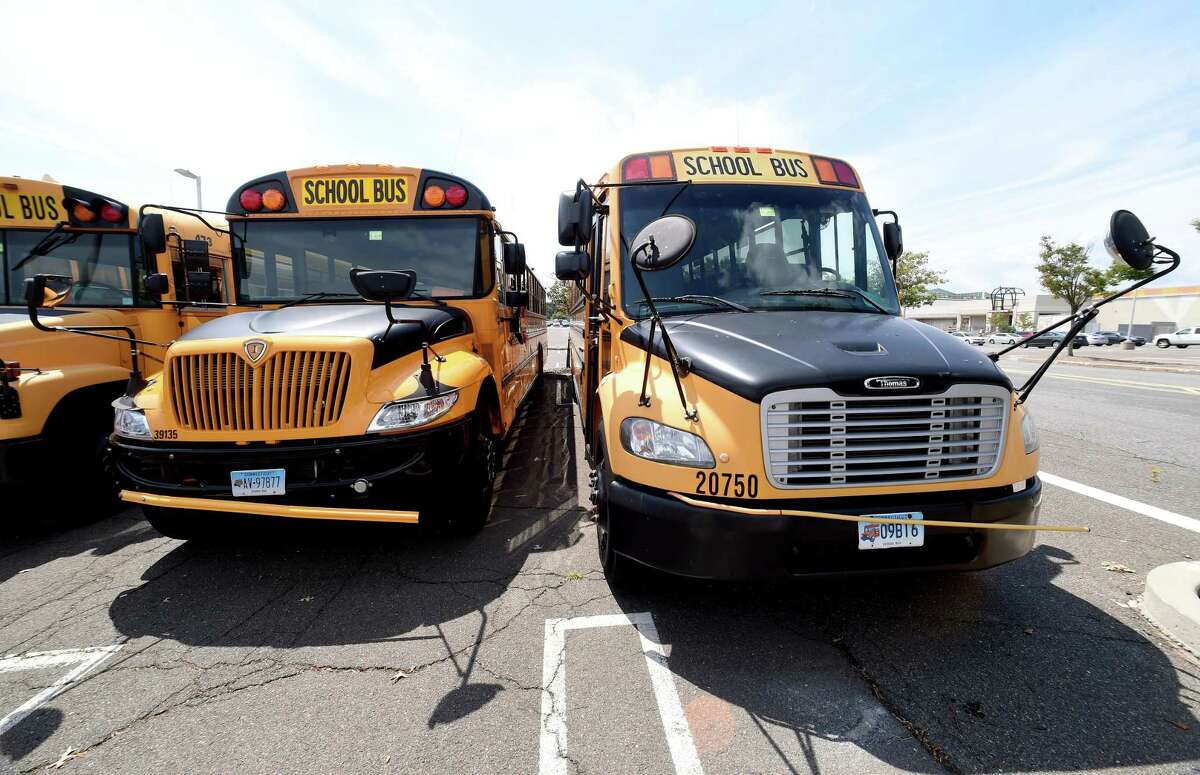 Durham School Services buses parked outside of the former Sears Auto Center at the Connecticut Post Mall in Milford on August 14, 2020