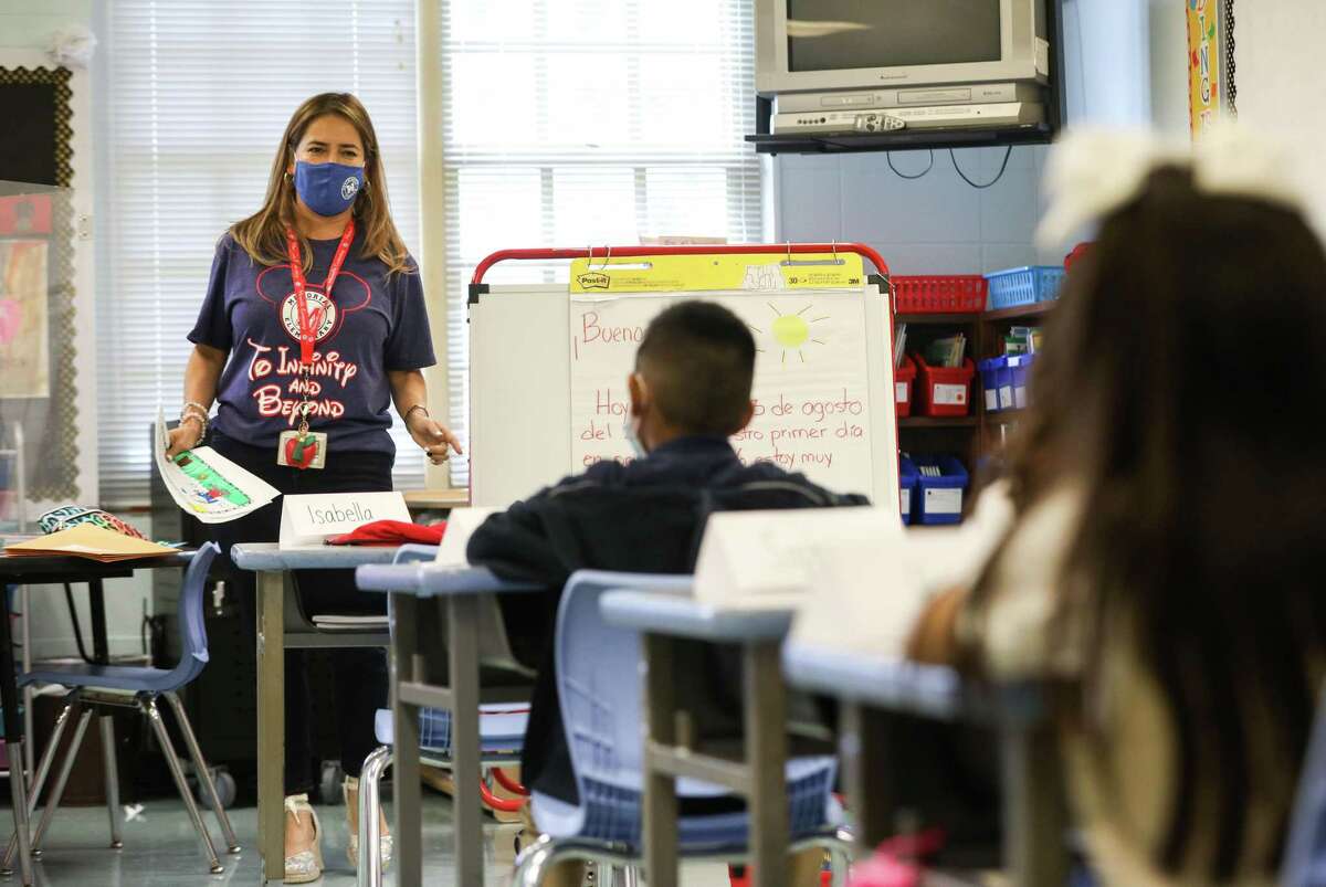 Claudia Talavera teaches her first-grade class during the first day of classes in Houston Independent School District at Memorial Elementary School in 2021. Attorney General Ken Paxton and Republicans in the Legislature are taking aim at HISD, saying that the district’s COVID sick day policy violates Texas law.