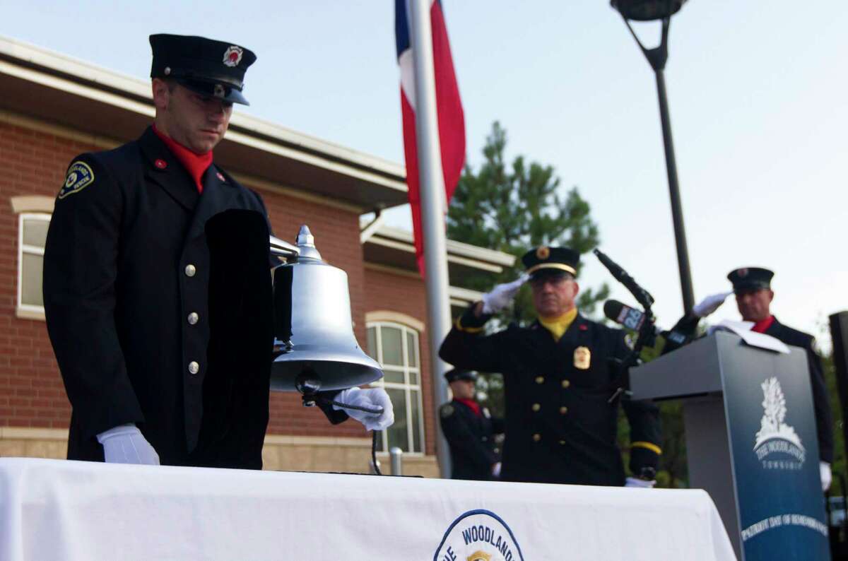 A member of The Woodlands Firefighter honor guard rings a bell in remembrance of the nearly 3,000 victims of the terror attacks on September 11 during a ceremony at The Woodlands Central Fire Station on Sept. 11, 2019.