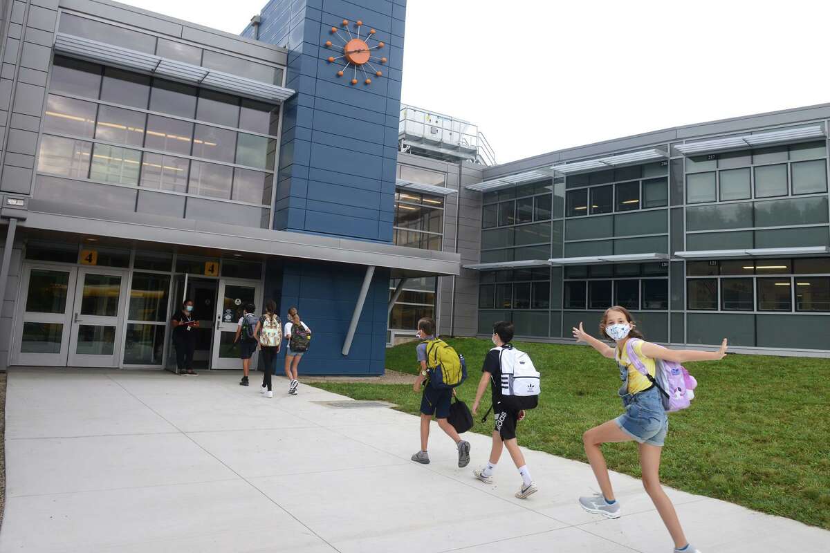 Students arrive for the first day of classes at Coleytown Middle School, in Westport, Conn. Aug. 31, 2021.