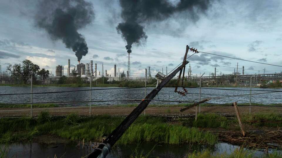 LAPLACE LA - AUGUST 30 Broken power lines, destroyed by Hurricane Ida, are seen along a highway near a petroleum refinery on August 30, 2021 outside LaPlace, Louisiana. Idas eastern wall went right over LaPlace inflicting heavy damage on the area. (Photo by Michael Robinson Chavez/The Washington Post via Getty Images)