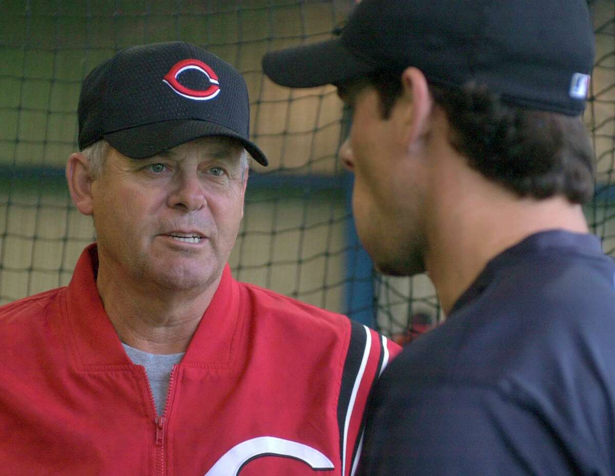 Cincinnati Reds manager Bob Boone, left, talks with his son, Reds third baseman Aaron Boone, in the batting cage at the team’s spring training camp in Sarasota, Fla., on Feb. 22, 2002.