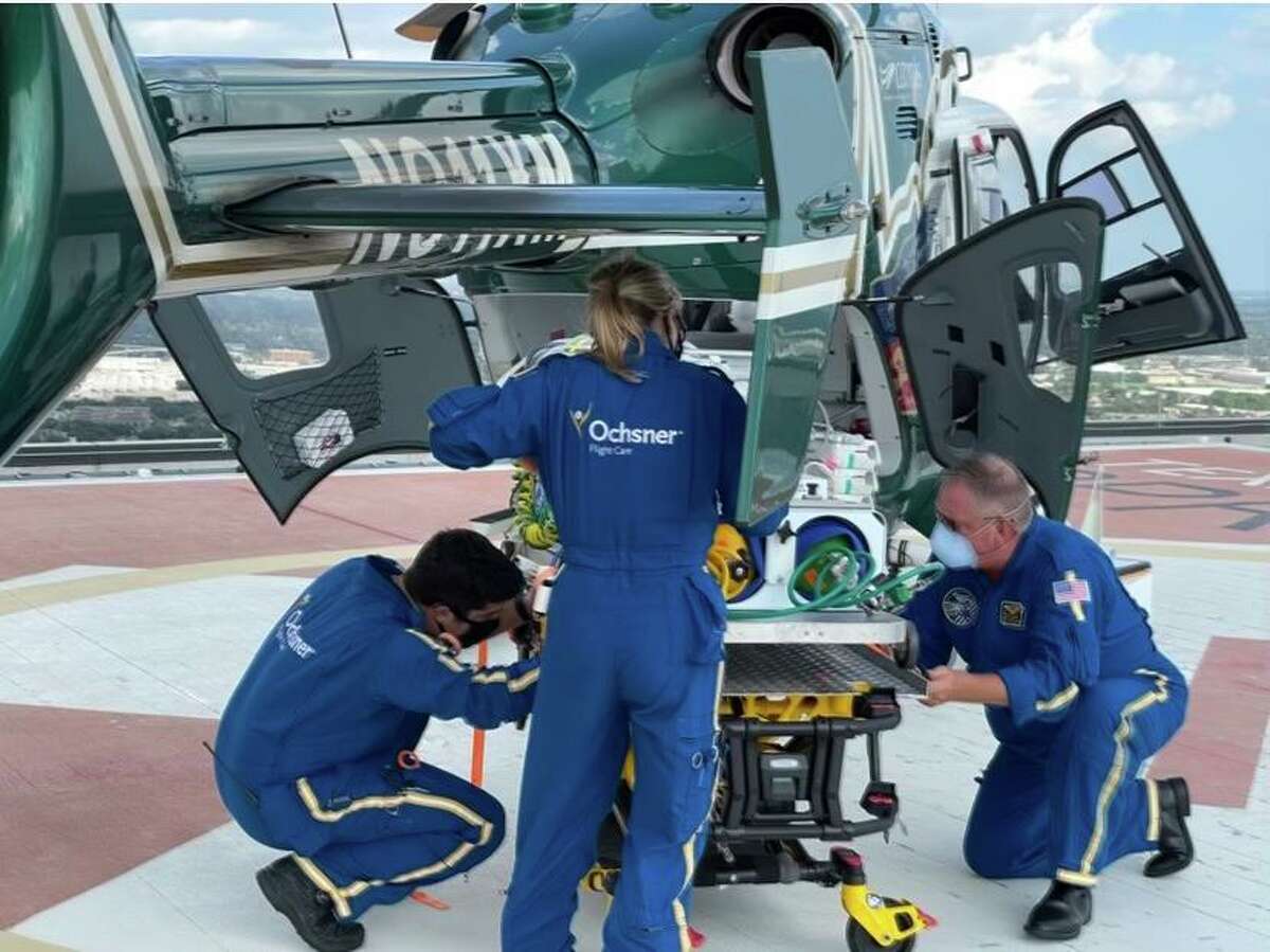 A flight crew from Louisiana’s Ochsner Health delivers a critically ill infant from a hurricane-battered hospital near New Orleans to Texas Children’s Hospital Tuesday, Aug. 31, 2021 in Houston. The Houston hospital is expecting to receive at least two more infants from Ochsner Health in the coming days.